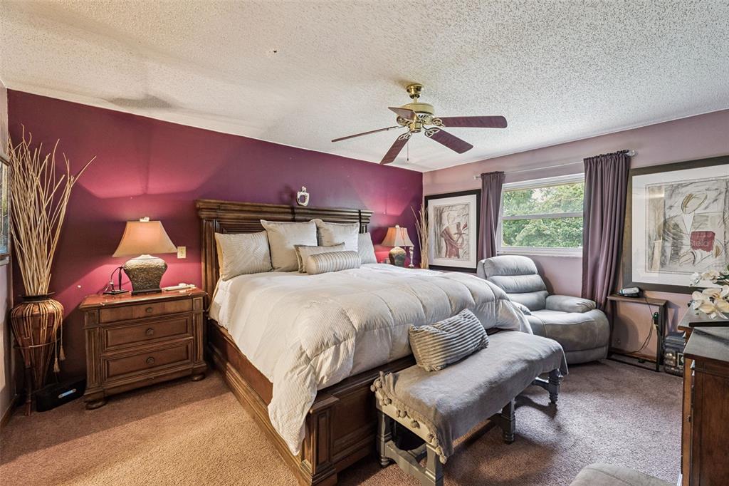 611 North Forsyth Road Orlando, FL 32807 - Photo 11 of 36 a spacious bedroom with a bed a chandelier and a couch