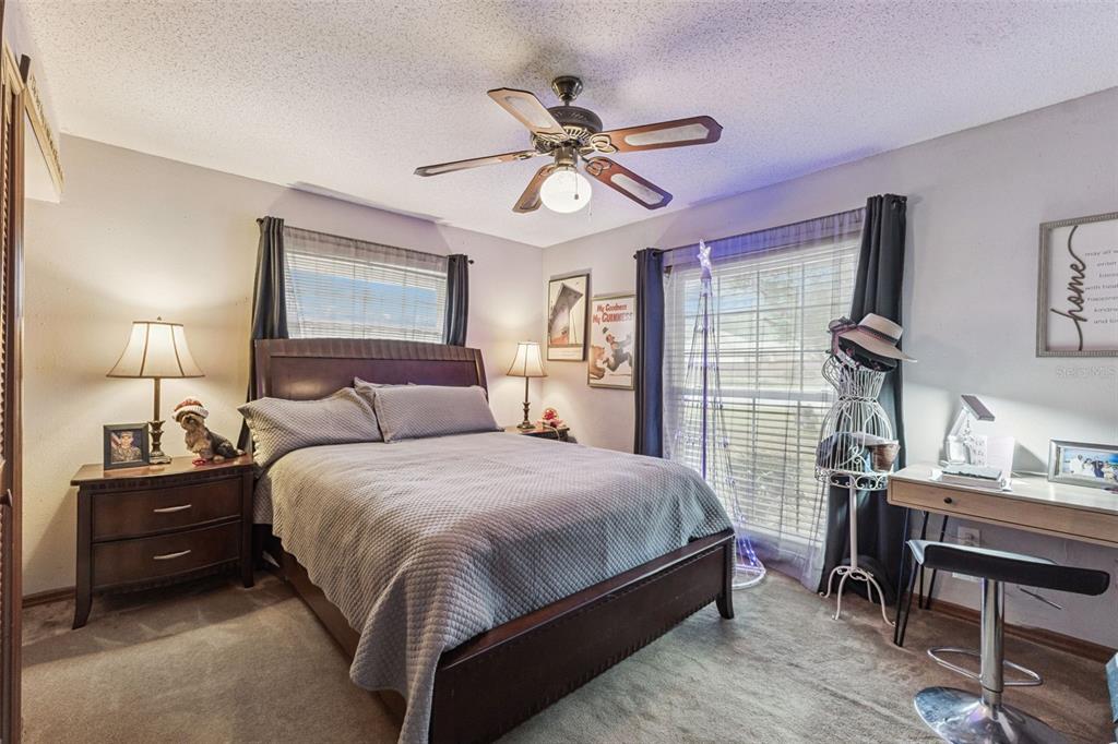 611 North Forsyth Road Orlando, FL 32807 - Photo 13 of 36 a bedroom with a bed and a chandelier