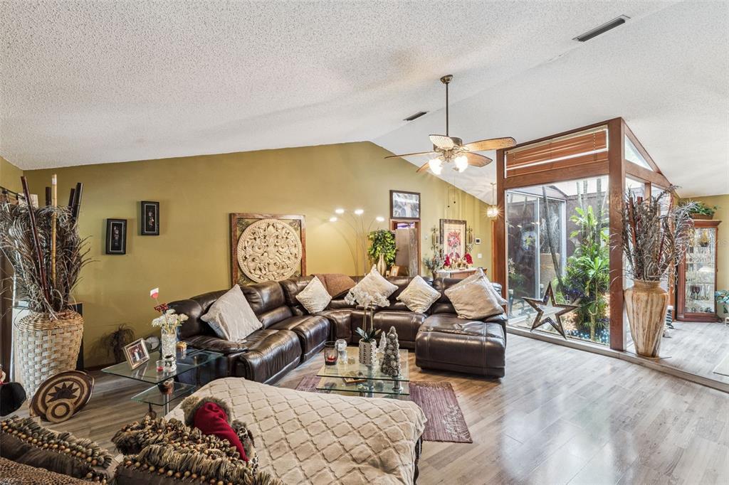 611 North Forsyth Road Orlando, FL 32807 - Photo 22 of 36 a living room with furniture and a chandelier