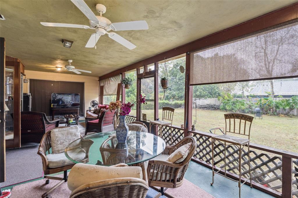 611 North Forsyth Road Orlando, FL 32807 - Photo 28 of 36 a living room with furniture floor to ceiling window and a table
