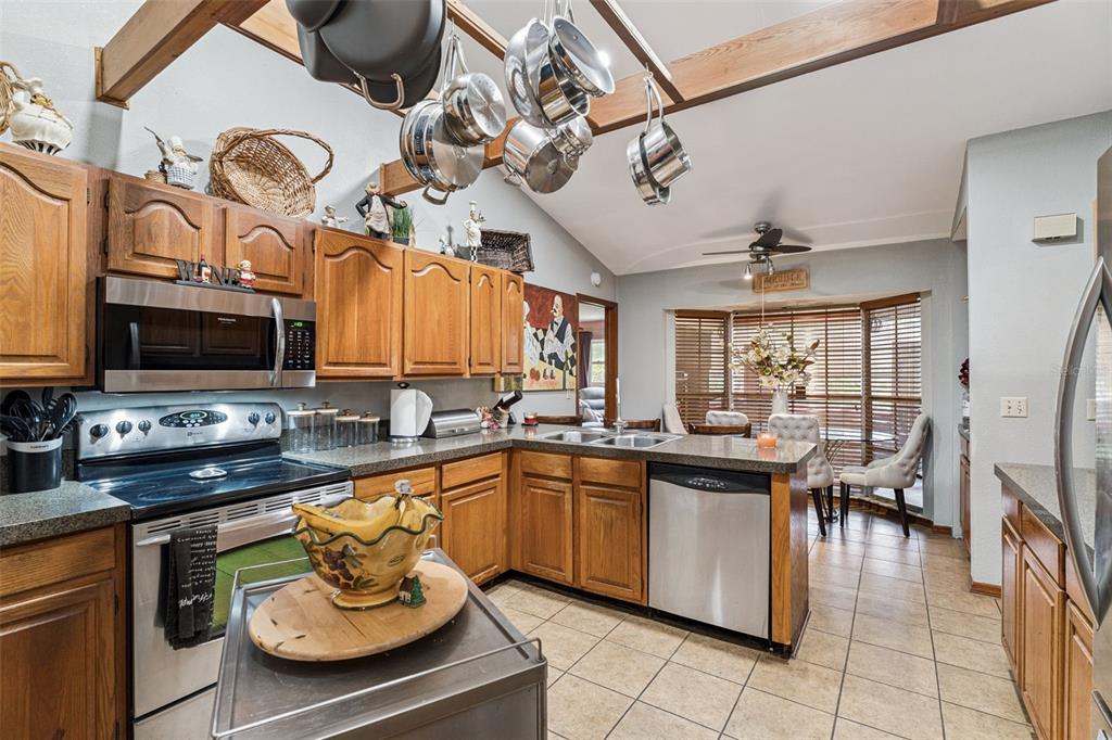 611 North Forsyth Road Orlando, FL 32807 - Photo 5 of 36 a kitchen with a sink appliances and cabinets