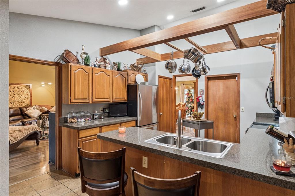 611 North Forsyth Road Orlando, FL 32807 - Photo 7 of 36 a kitchen with a sink a counter and chairs