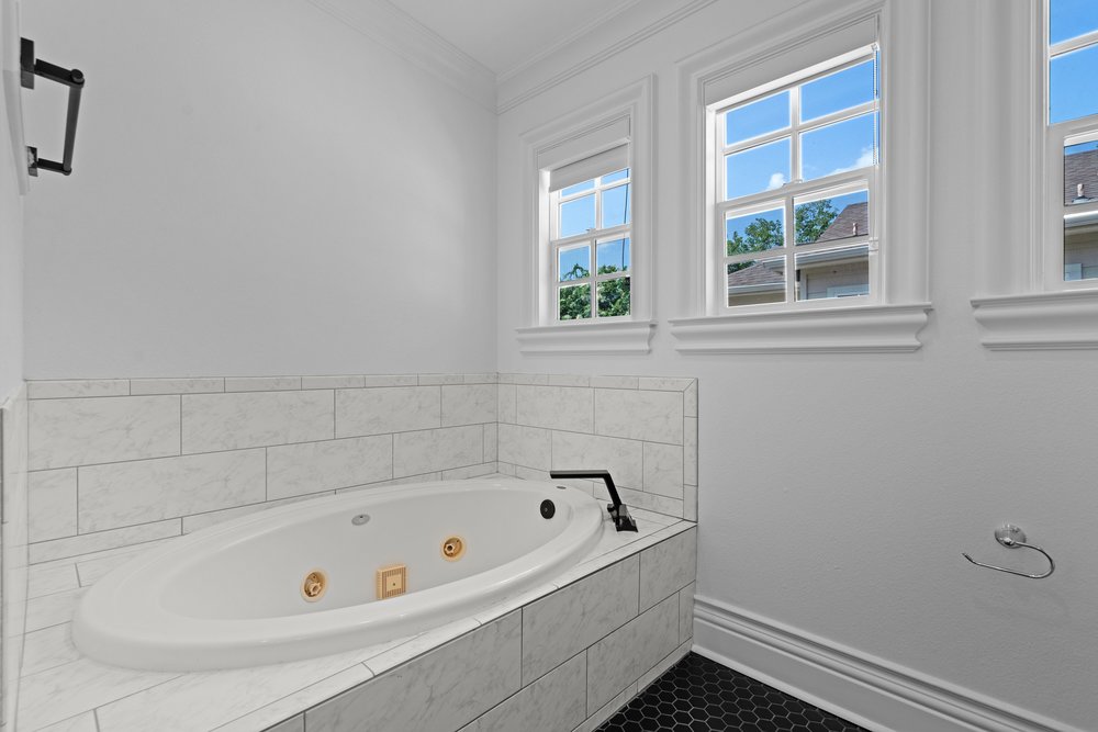 1609 Hartford Road, Unit A Austin, TX 78703 - Photo 28 of 39 Indulge in a tranquil bathing experience with this spacious soaking tub and naturally illuminated windows.