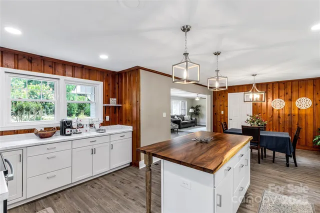 a view of a kitchen counter top space a sink appliances and living room view