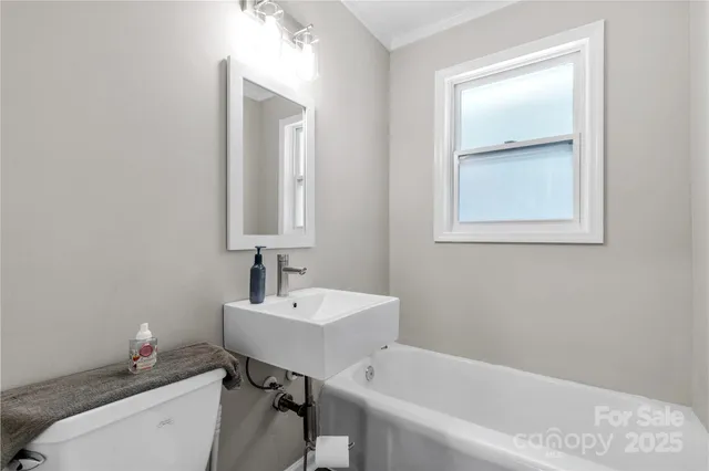 a bathroom with a sink a toilet and tub