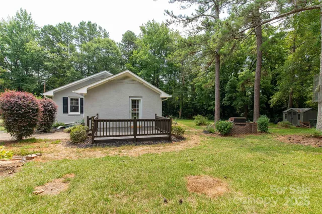 a view of a house with a yard and sitting area
