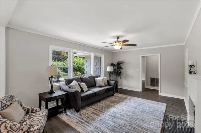 a living room with furniture and a chandelier