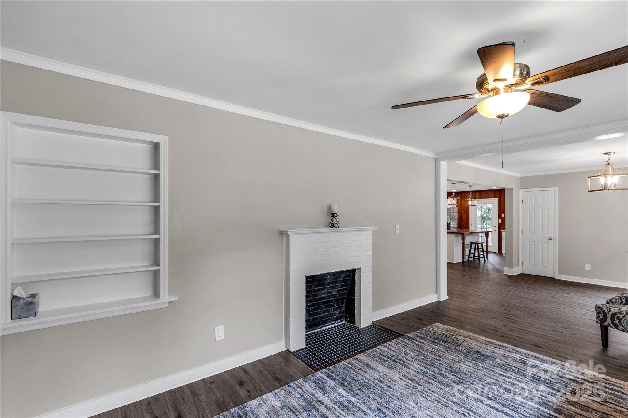 1641 Converse Street Lancaster, SC 29720 - Photo 7 of 33 a view of a livingroom with a fireplace a ceiling fan and wooden floor
