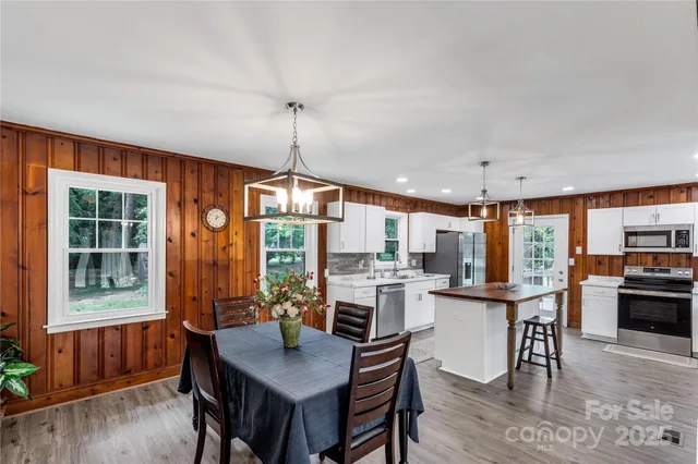 a open kitchen with stainless steel appliances granite countertop a stove and refrigerator