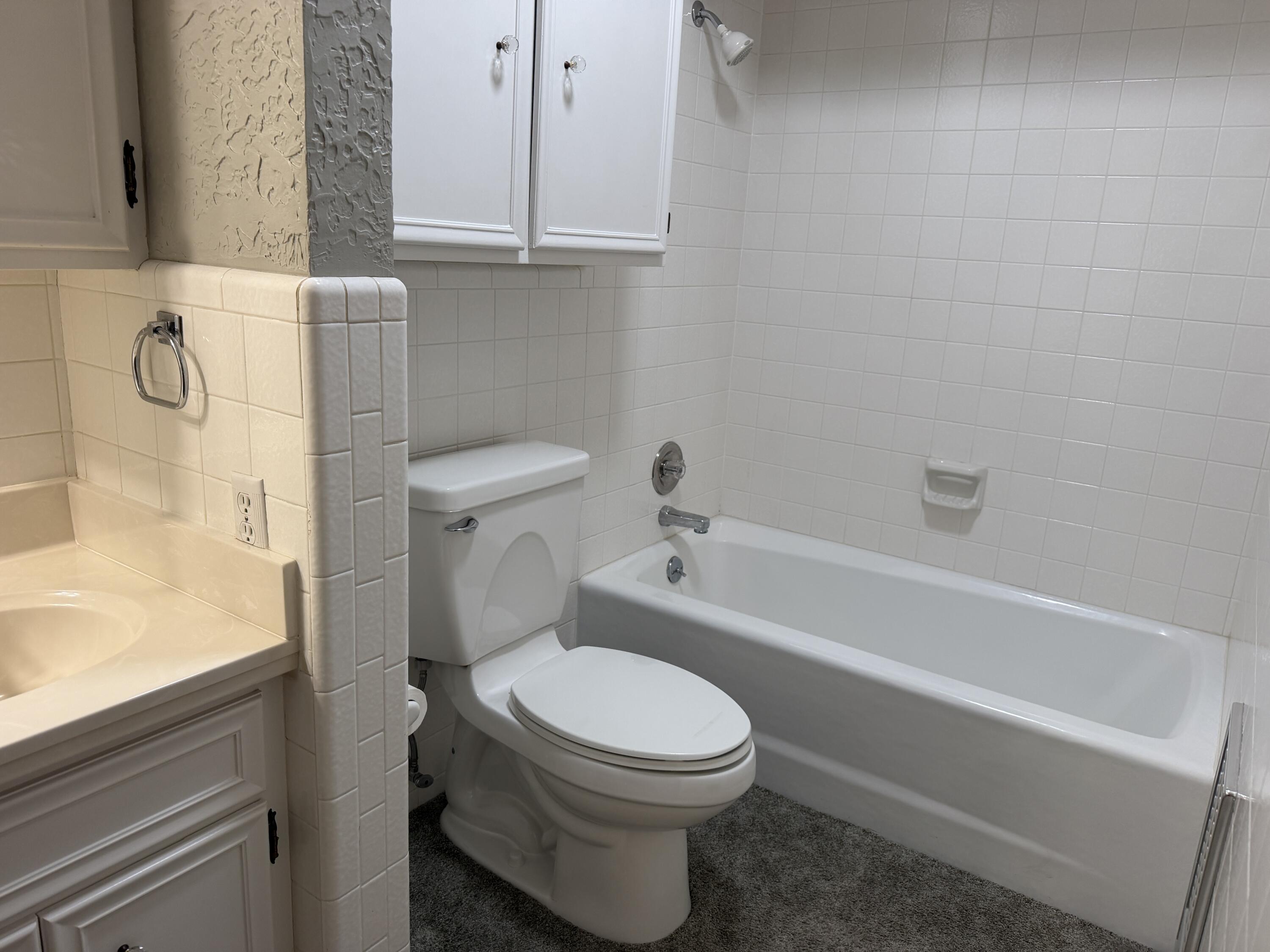 1603 South 8th Street Lamesa, TX 79331 - Photo 13 of 39 a bathroom with a toilet and a bathtub