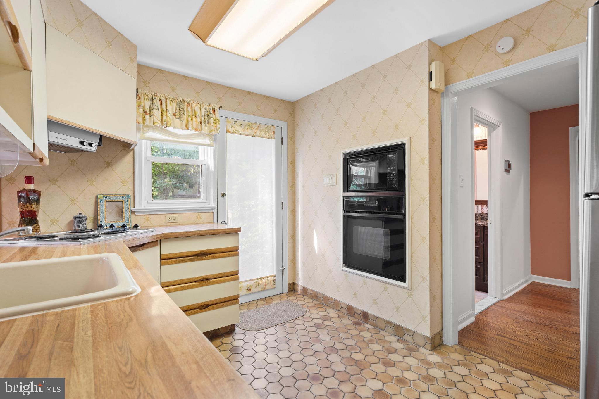 610 Broad Acres Road Penn Valley, PA 19072 - Photo 12 of 41 a view of a kitchen with a sink and dishwasher with wooden floor