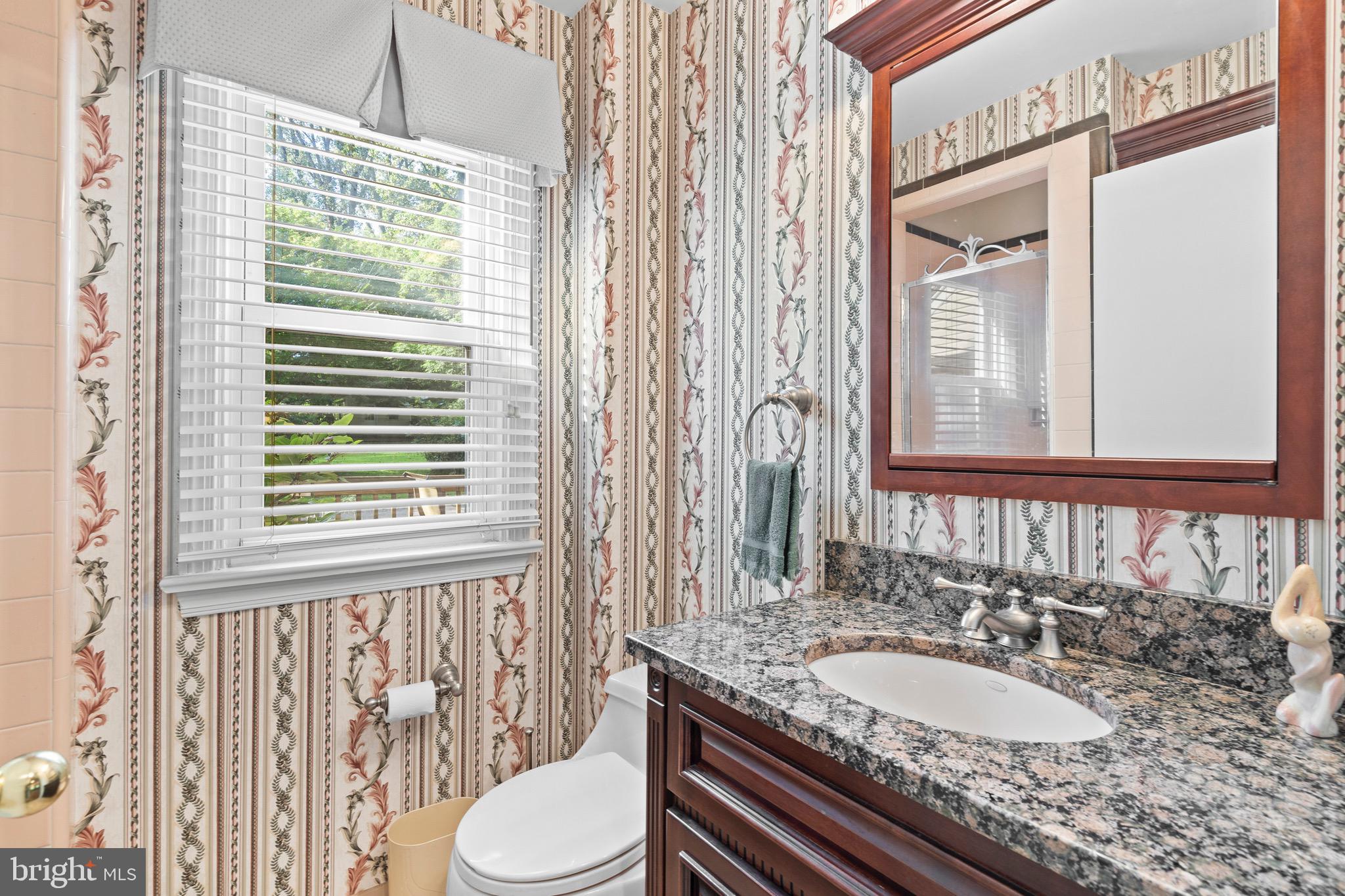 610 Broad Acres Road Penn Valley, PA 19072 - Photo 17 of 41 a bathroom with a granite countertop sink and a mirror