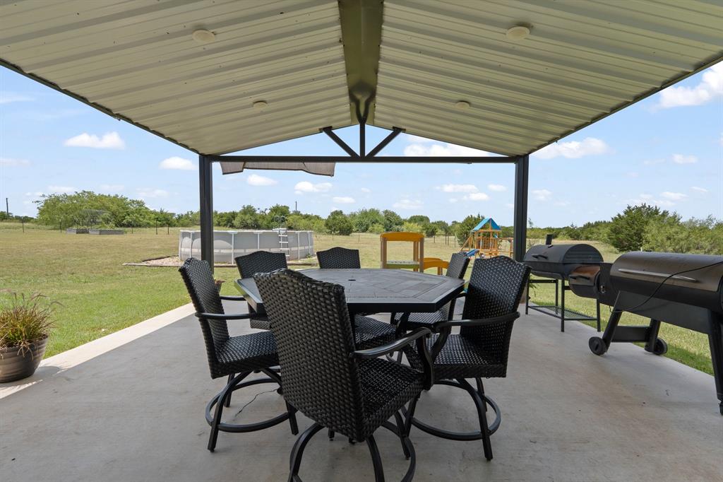 1031 Augustus Court Rio Vista, TX 76093 - Photo 20 of 30 Expansive covered patio with a metal roof and concrete flooring
