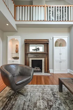 a living room with furniture pool table and a fireplace
