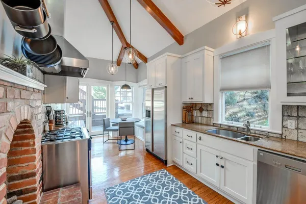 a kitchen with lots of counter top space and furniture