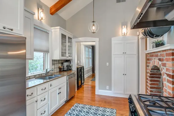 a kitchen with stainless steel appliances granite countertop a stove and a refrigerator