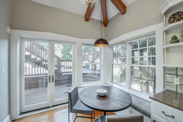 a view of a dining room with furniture wooden floor and chandelier