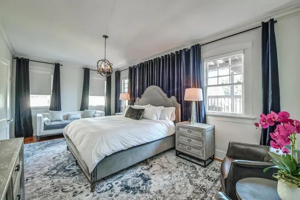 a bedroom with a bed window and couch