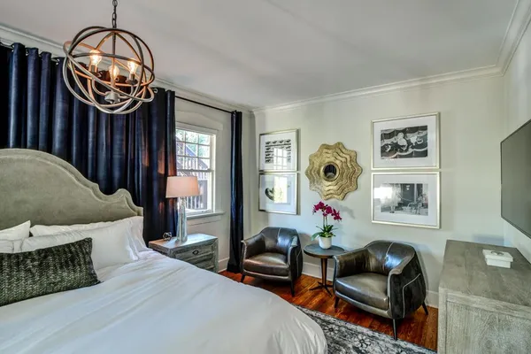 a bedroom with bed and a chandelier