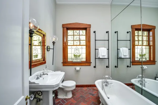 a bathroom with a sink a toilet and a mirror