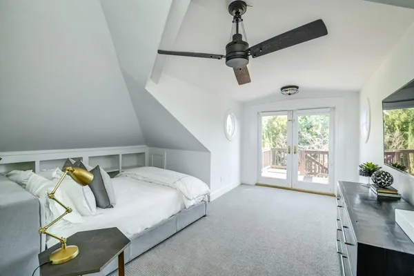 a bedroom with a bed couch and window