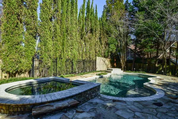 a backyard of a house with outdoor seating