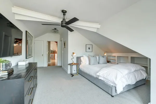 a bedroom with a bed couch and a window