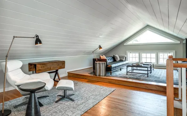 a bedroom with furniture and a wooden floor