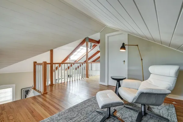 a livingroom with furniture a rug and wooden floor