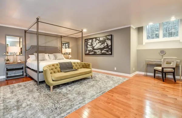 a bedroom with a bed and a couch