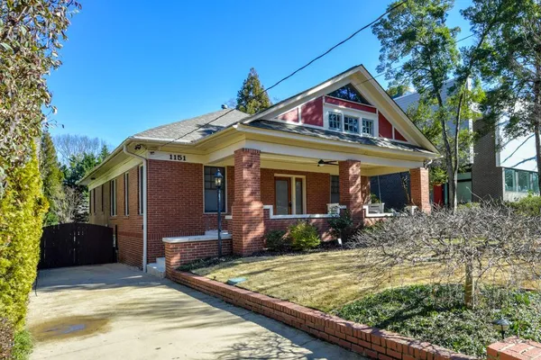 a front view of house with yard outdoor seating and barbeque oven
