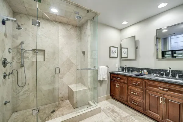 a spacious bathroom with a shower sink mirror and
