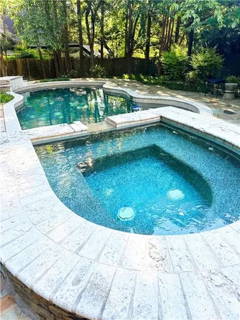 a view of a swimming pool with a yard