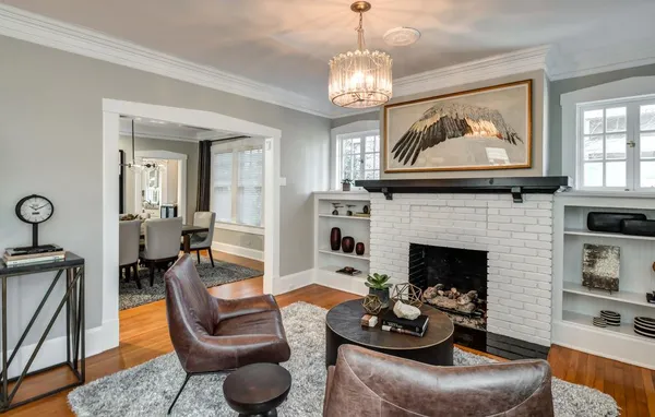 a living room with furniture a fireplace and windows