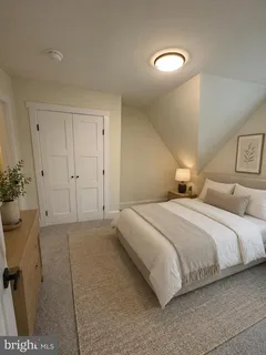 a bedroom with a bed and potted plant