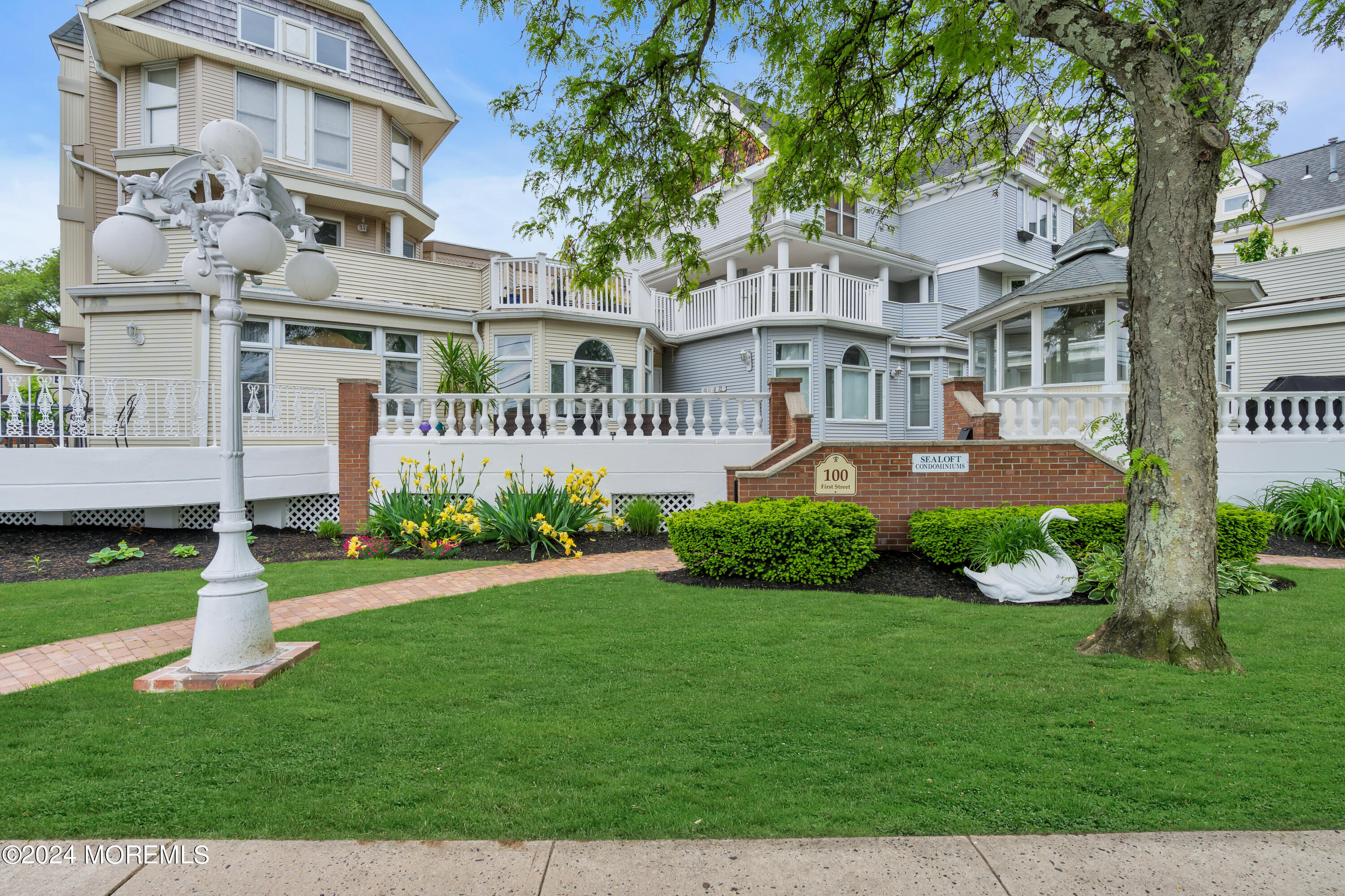 a front view of a residential apartment building with a yard