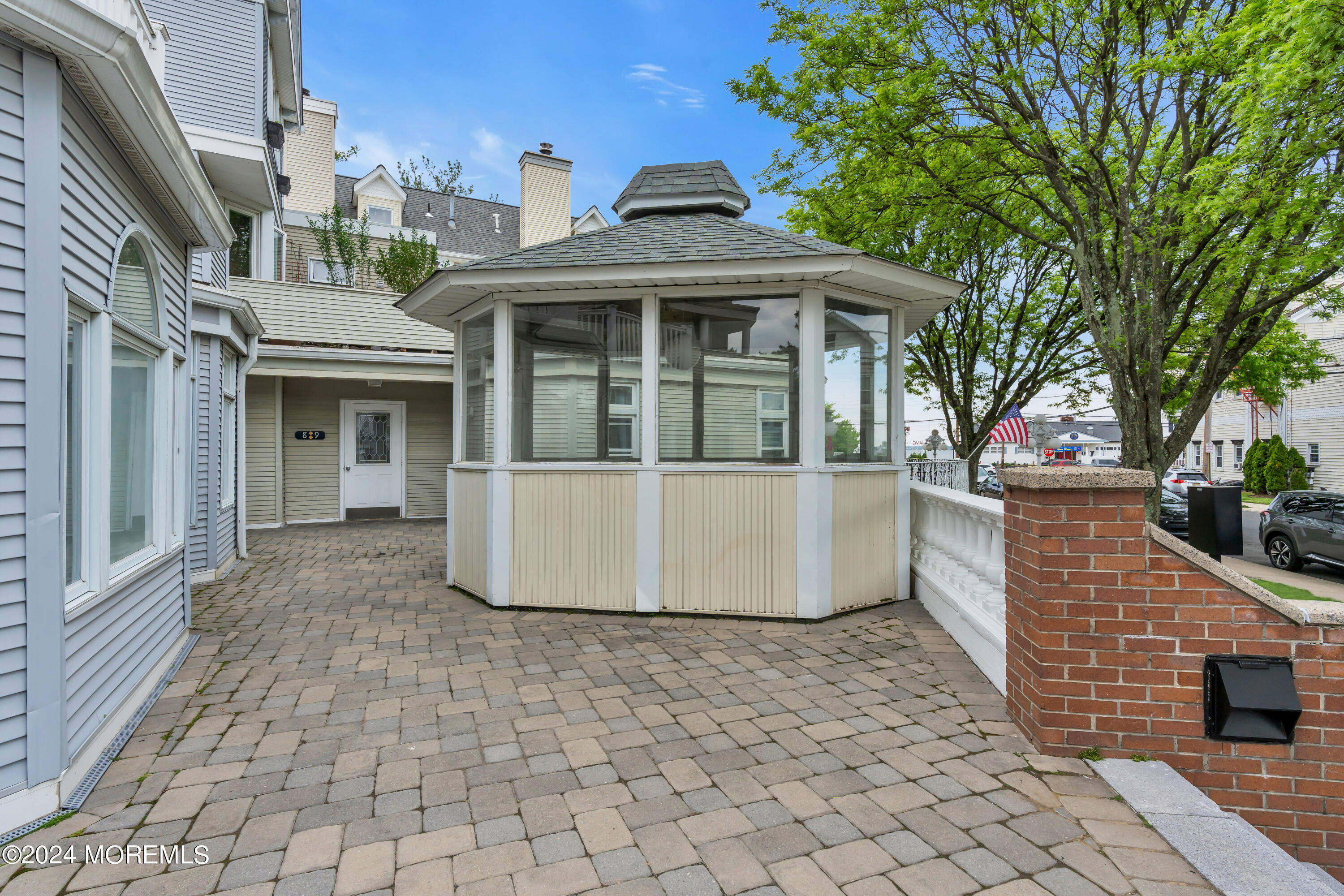 100 1st Street, Unit 8 Keyport, NJ 07735 - Photo 31 of 55 a view of a white house with large windows and a small yard