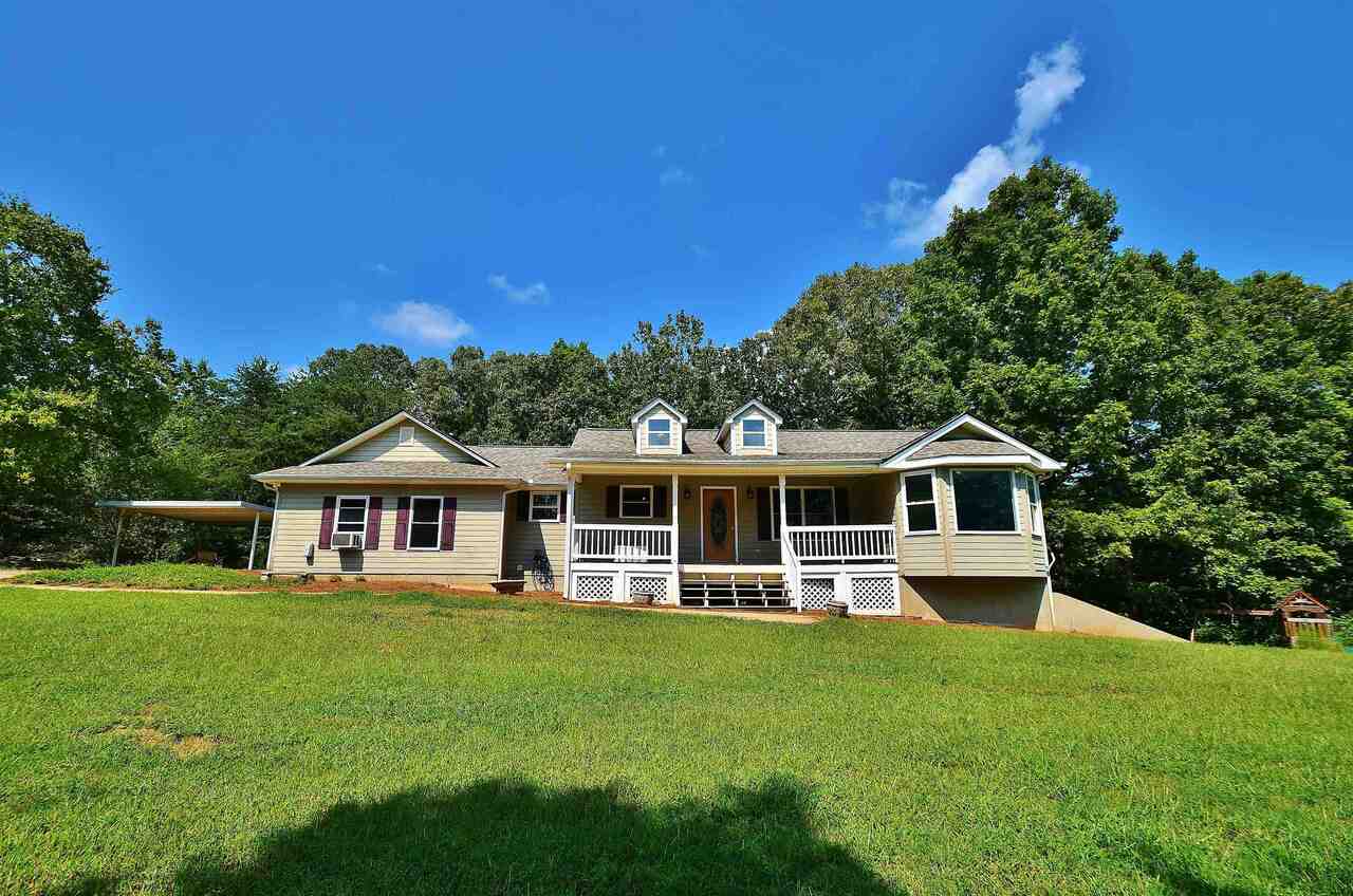 4143 Cagle Road Lula, GA 30554 - Photo 1 of 1 a front view of a house with a yard table and chairs