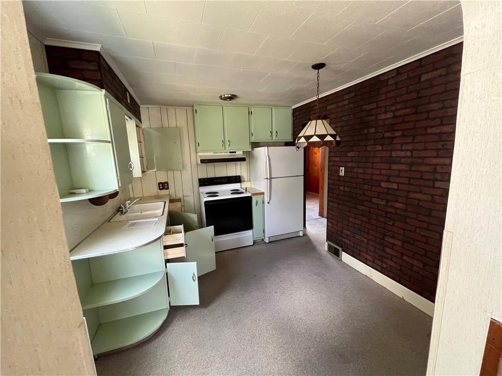 708 Nichols Street Clearfield, PA 16830 - Photo 7 of 12 a kitchen with a refrigerator and a stove