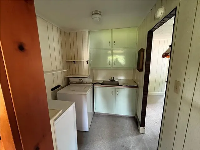 a kitchen with a refrigerator and a sink