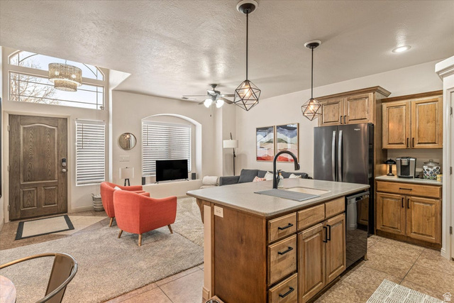 345 North 2450th Street East, Unit 152 St. George, UT 84790 - Photo 39 of 40 Kitchen featuring open floor plan, light countertops, freestanding refrigerator, an island with sink, and dishwashing machine