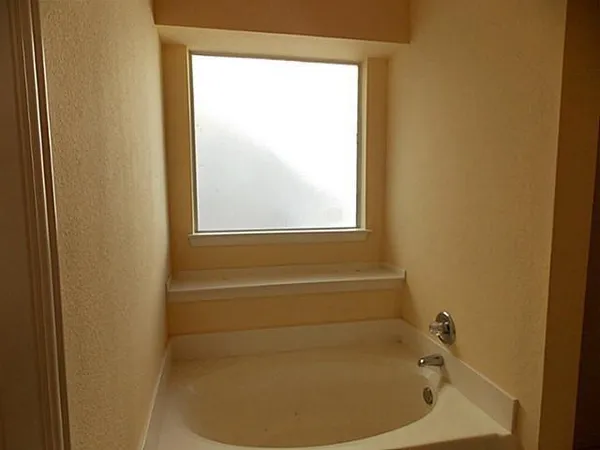 a bathroom with a tub and shower