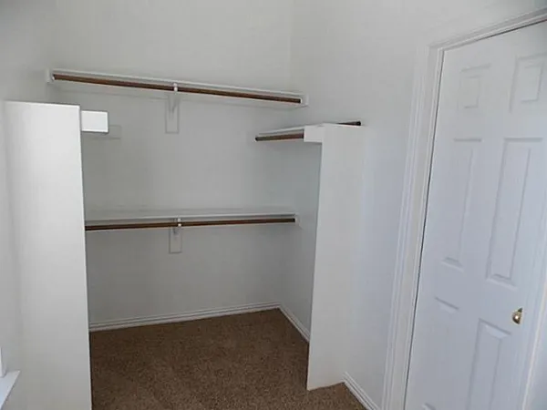 a view of an empty walk in closet
