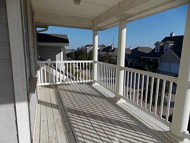 a view of a balcony with wooden floor