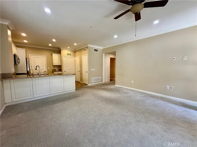 a view of large kitchen with a sink and stainless steel appliances