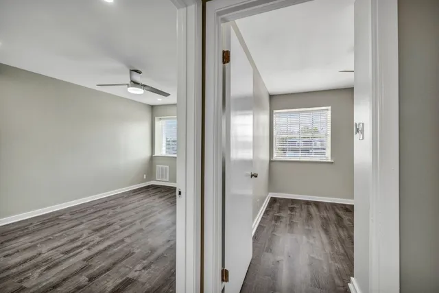 a view of hallway with wooden floor