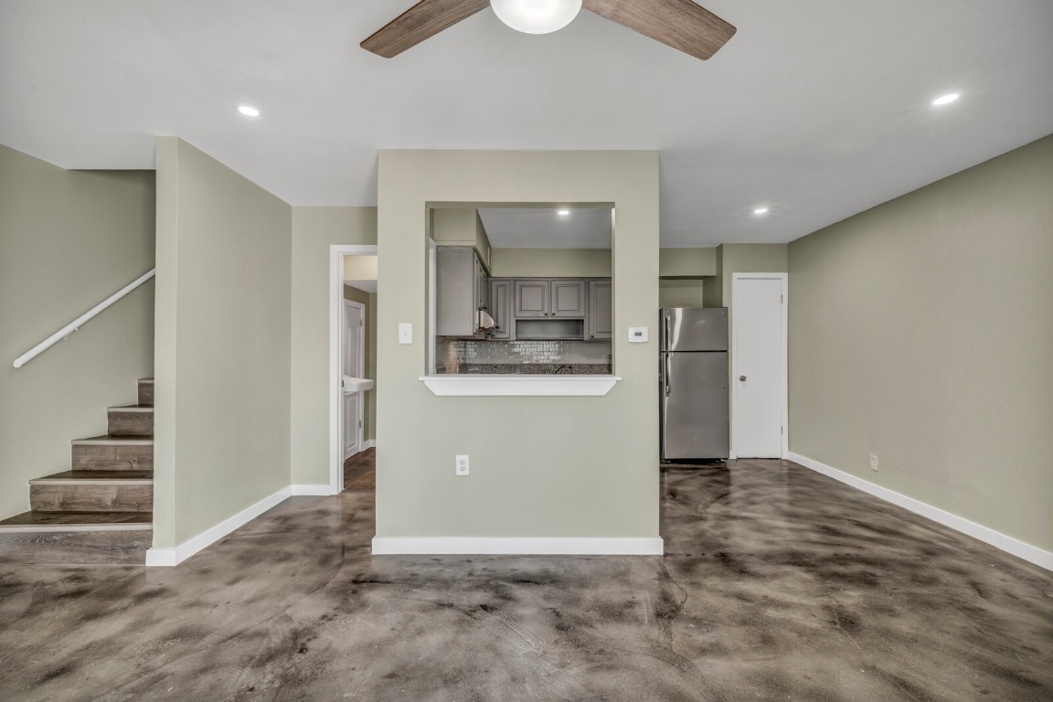 2808 Skyway Circle, Unit 101 Austin, TX 78704 - Photo 21 of 25 an empty room with wooden floor and kitchen view