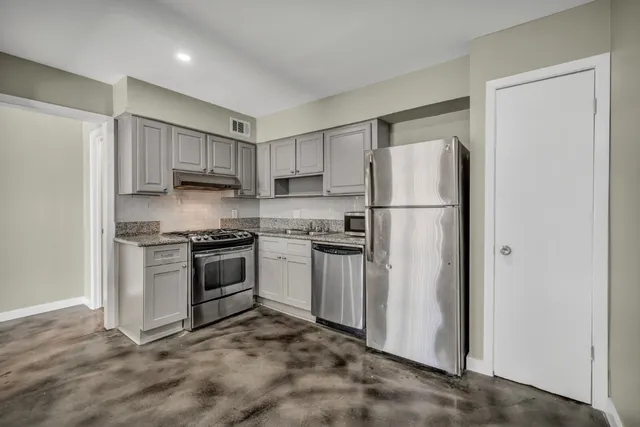 a kitchen with a refrigerator stove and sink