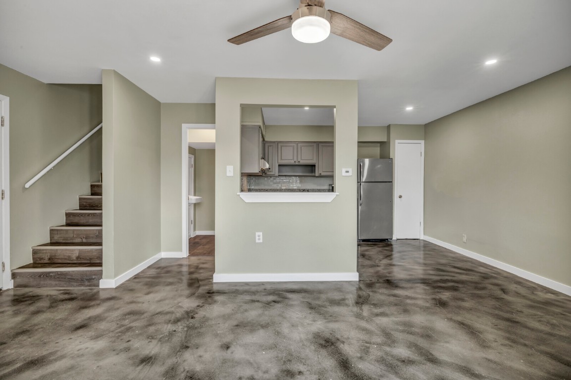 2808 Skyway Circle, Unit 101 Austin, TX 78704 - Photo 8 of 25 an empty room with wooden floor and staircase