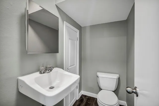 a white toilet sitting next to a white sink